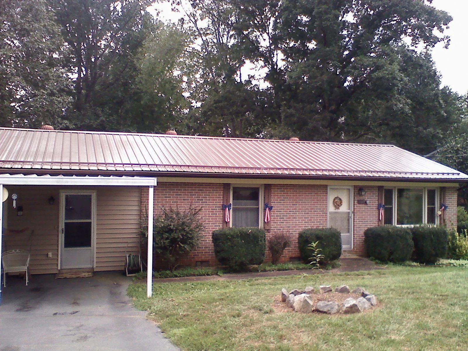 Bronze metal roof and carport on a brick ranch home — Roof Repair work by our crew in New Windsor